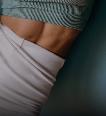 Close-up of a woman's toned midsection, highlighting the benefits of Omni-Biotic probiotics for women's digestive health and wellness