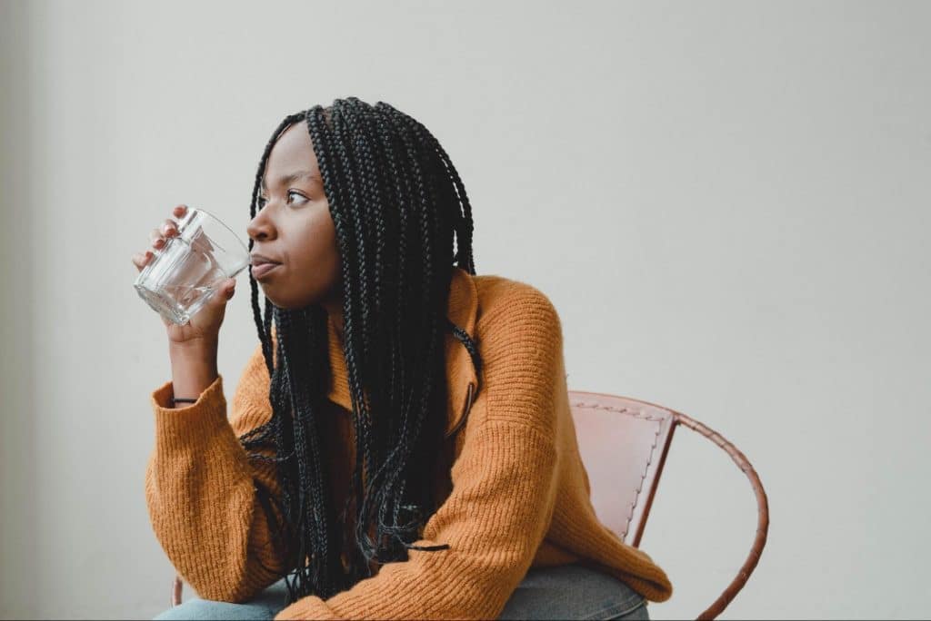 black woman drinking water