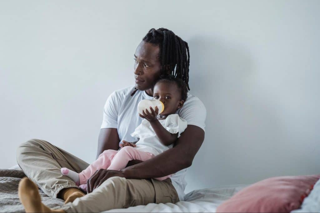 Father holding infant daughter