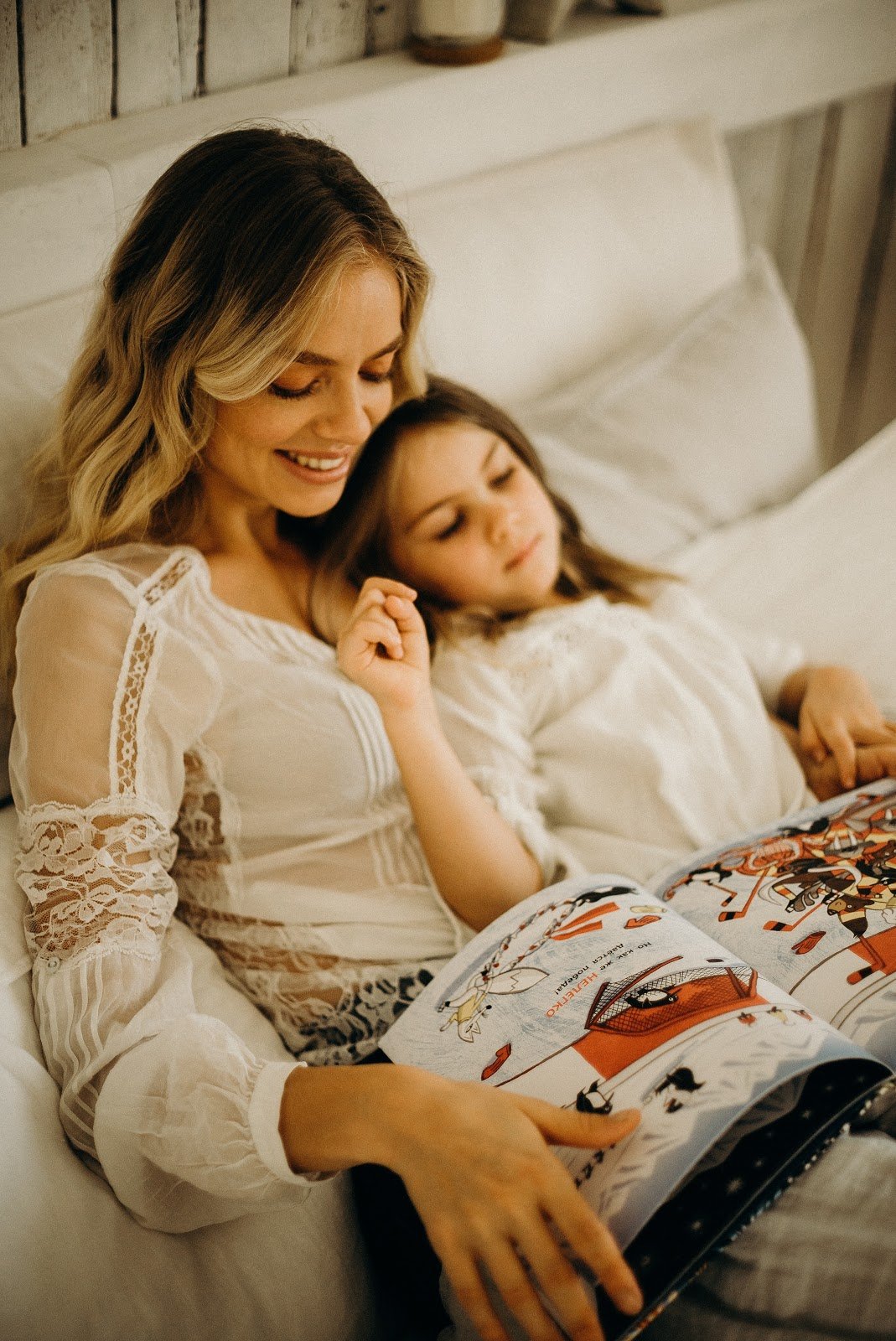 woman-and-child-in-bed-reading-magazine