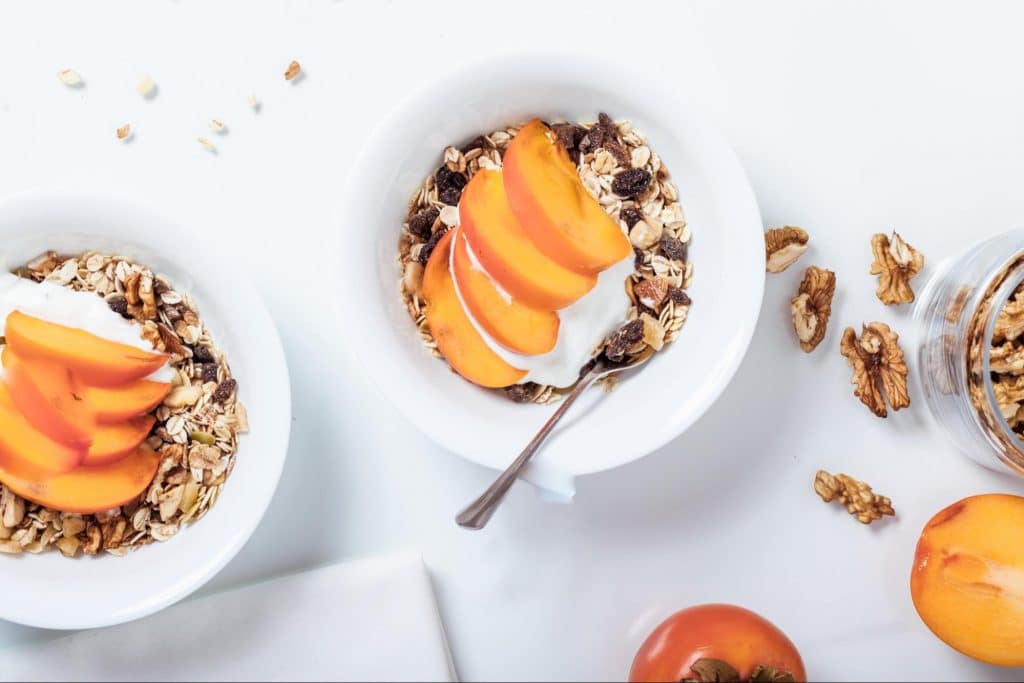 Healthy yogurt snack with granola and peaches.