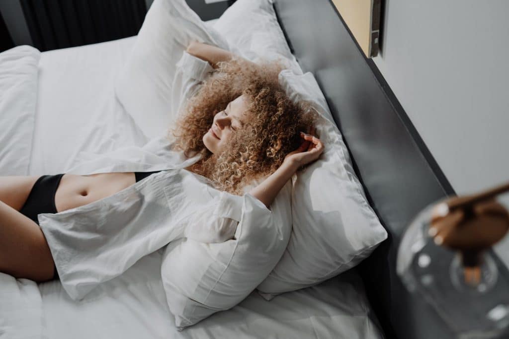 vegan woman laying on her bed and smiling