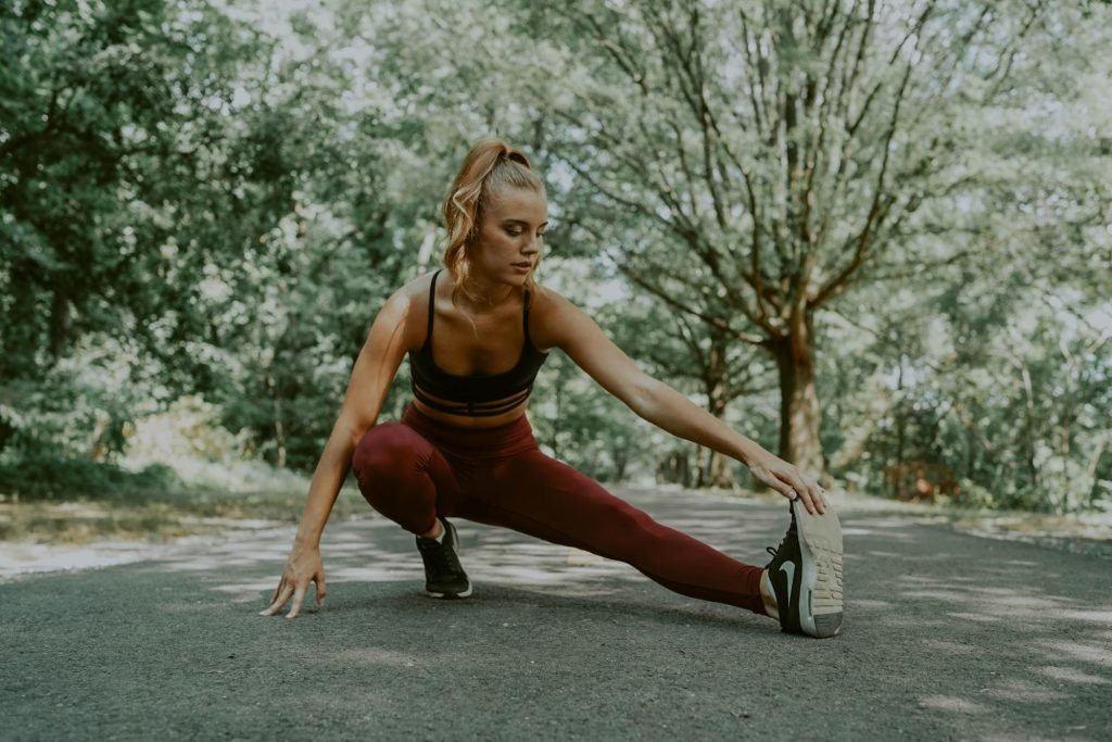 Prebiotics have been shown to help with weight loss. In this image a woman stretches before exercising.