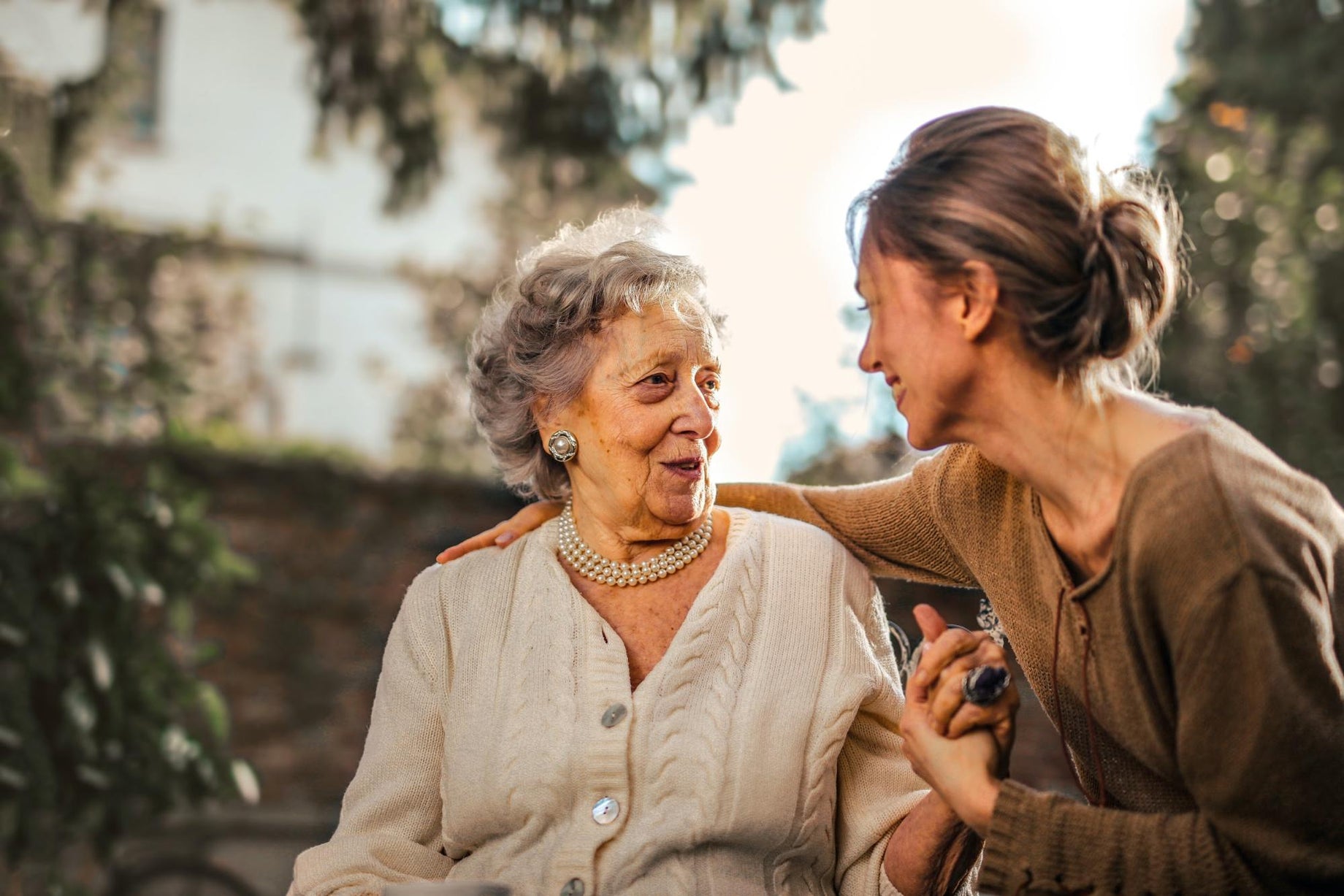 senior mother and her daughter sitting outdoors discussing best probiotics for seniors