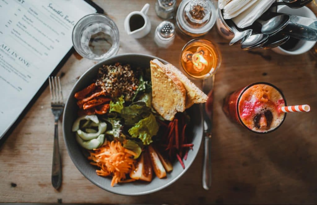 A salad bowl containing probiotic and prebiotic foods such as kale and cheese.