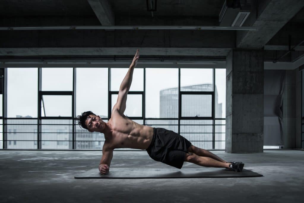 athletic-man-doing-yoga-stretch