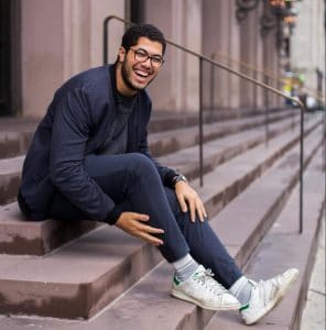 man-sitting-on-stair-while-smiling