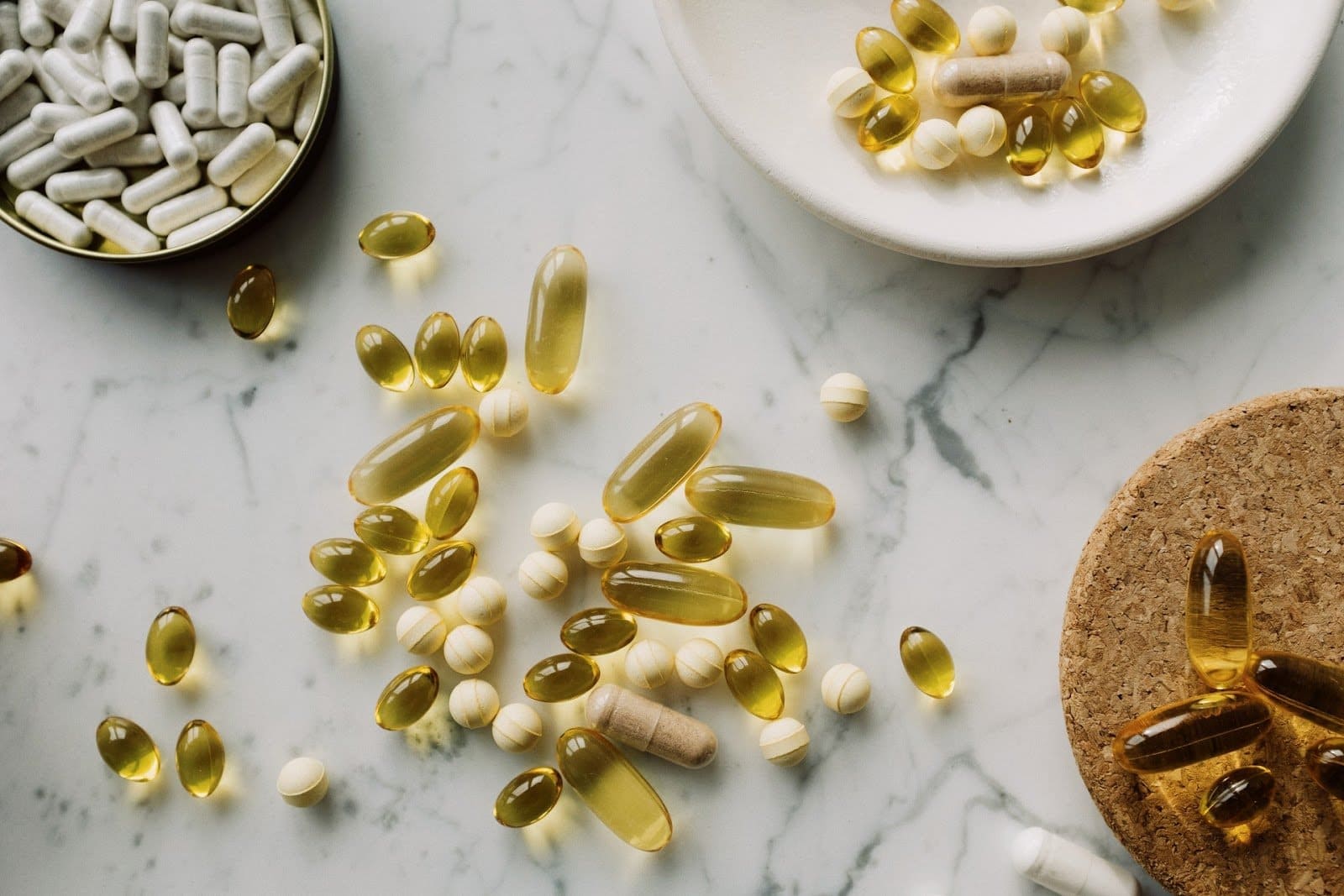 flat-lay-photo-of-various-pills-and-gel-capsules-in-white-brown-and-beige