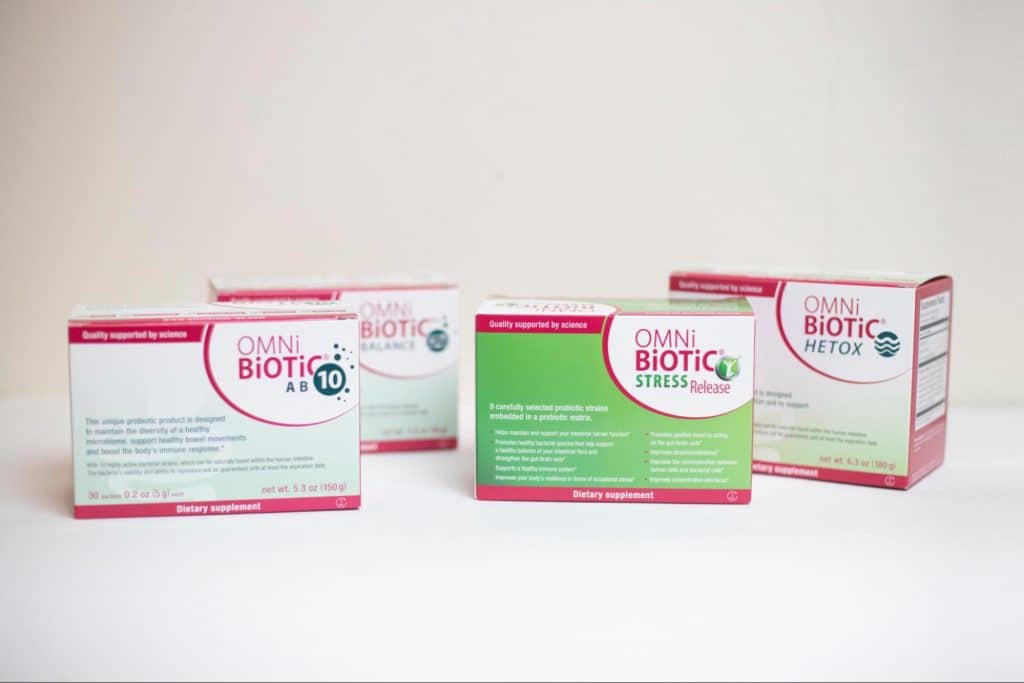 Probiotic supplements from Omni-Biotic arranged in a row to display the product range and packaging.