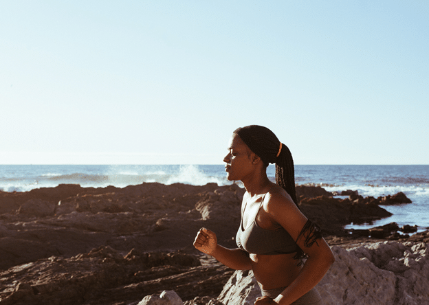 woman-running-on-rocky-beach