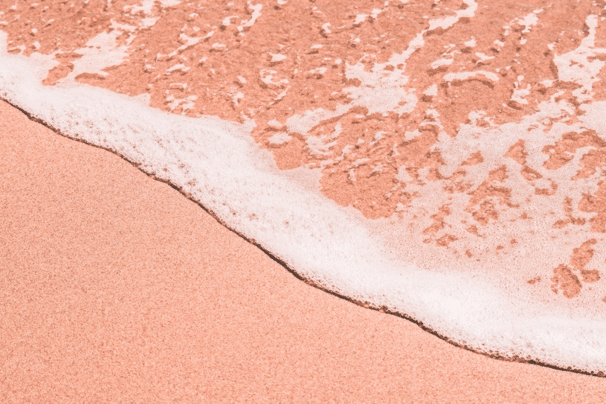 wave-on-a-sandy-pink-beach