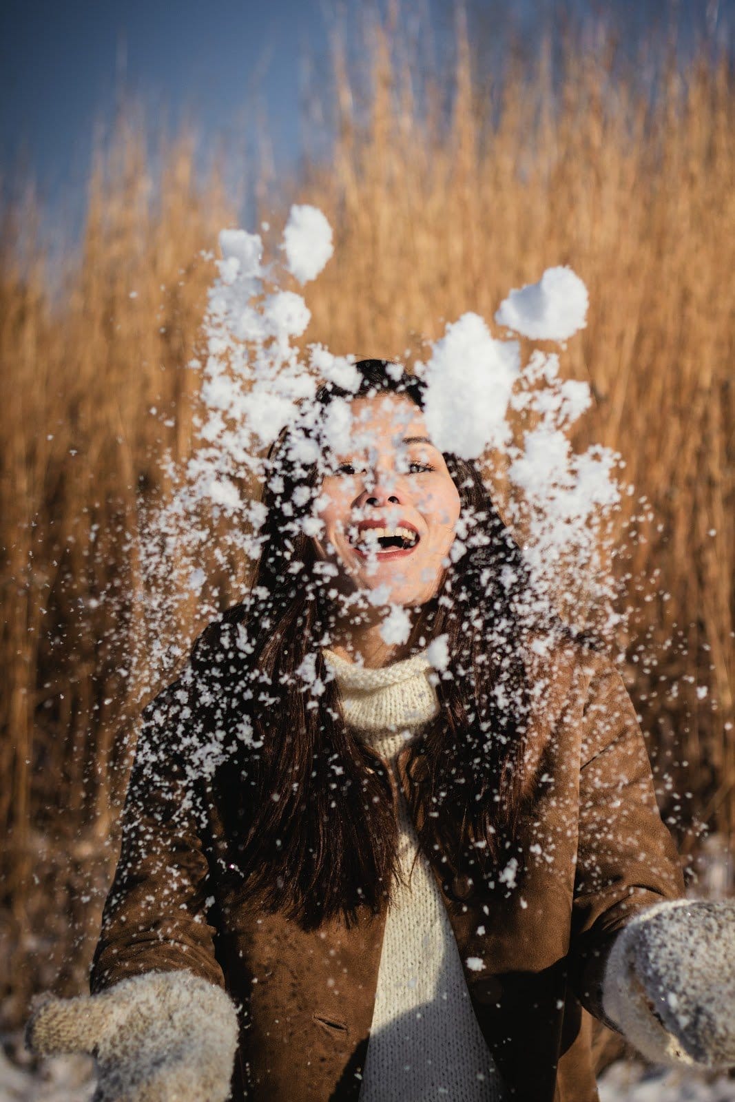 photo-of-woman-playing-with-snow