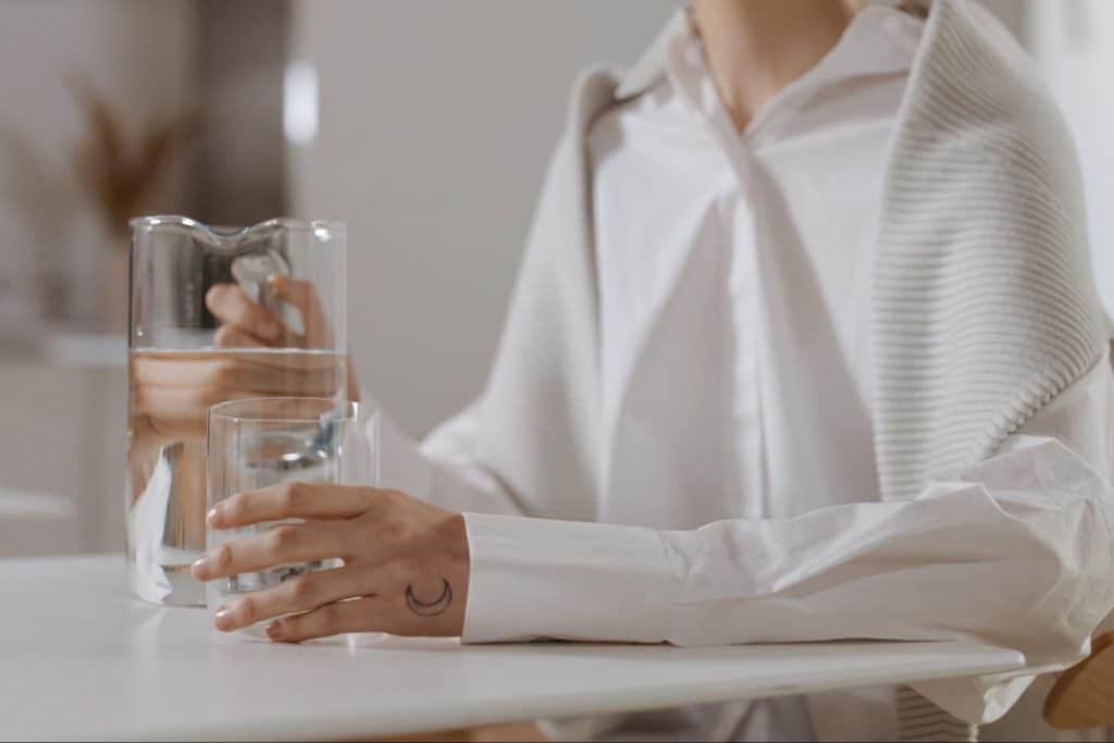 Professional woman prepares probiotic drink to start her day.