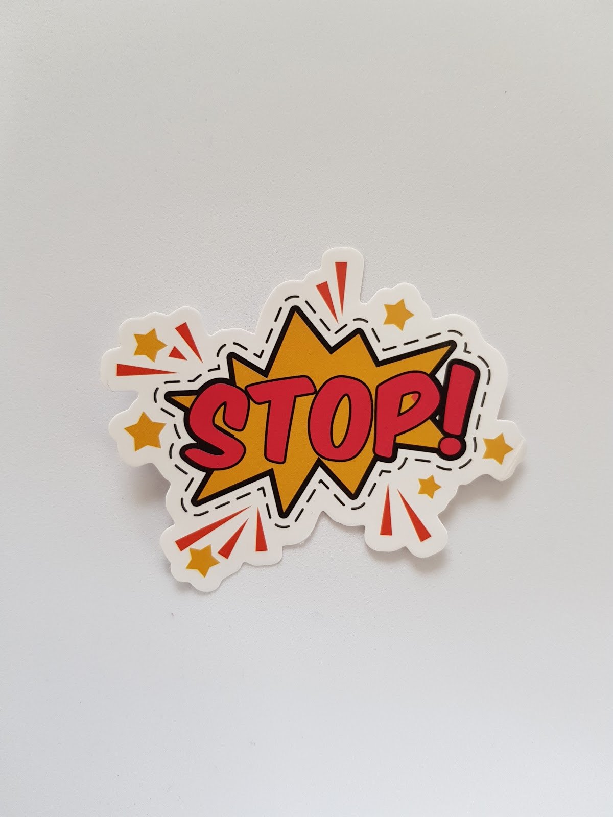 Red and yellow stop sticker