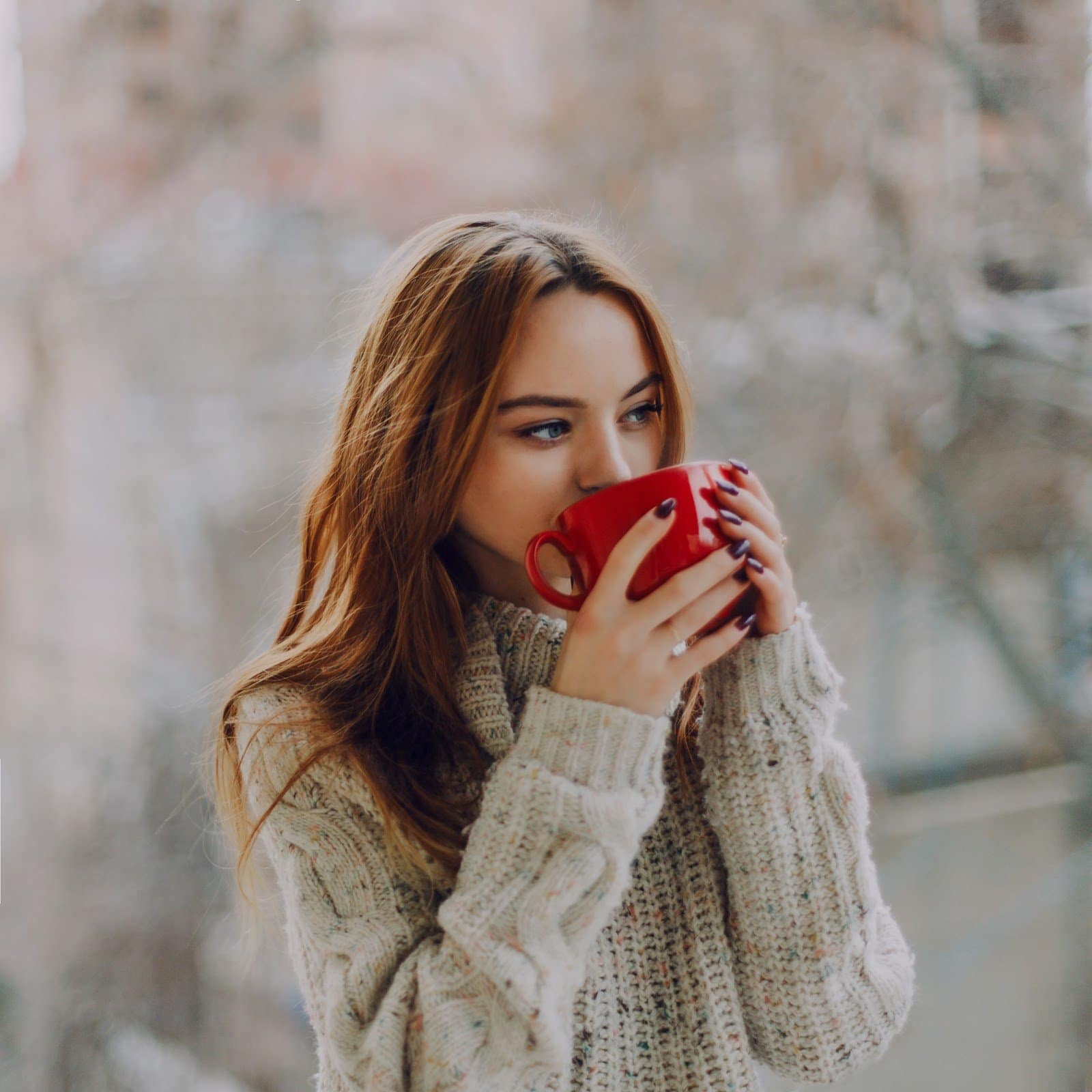 woman-holding-red-ceramic-cup