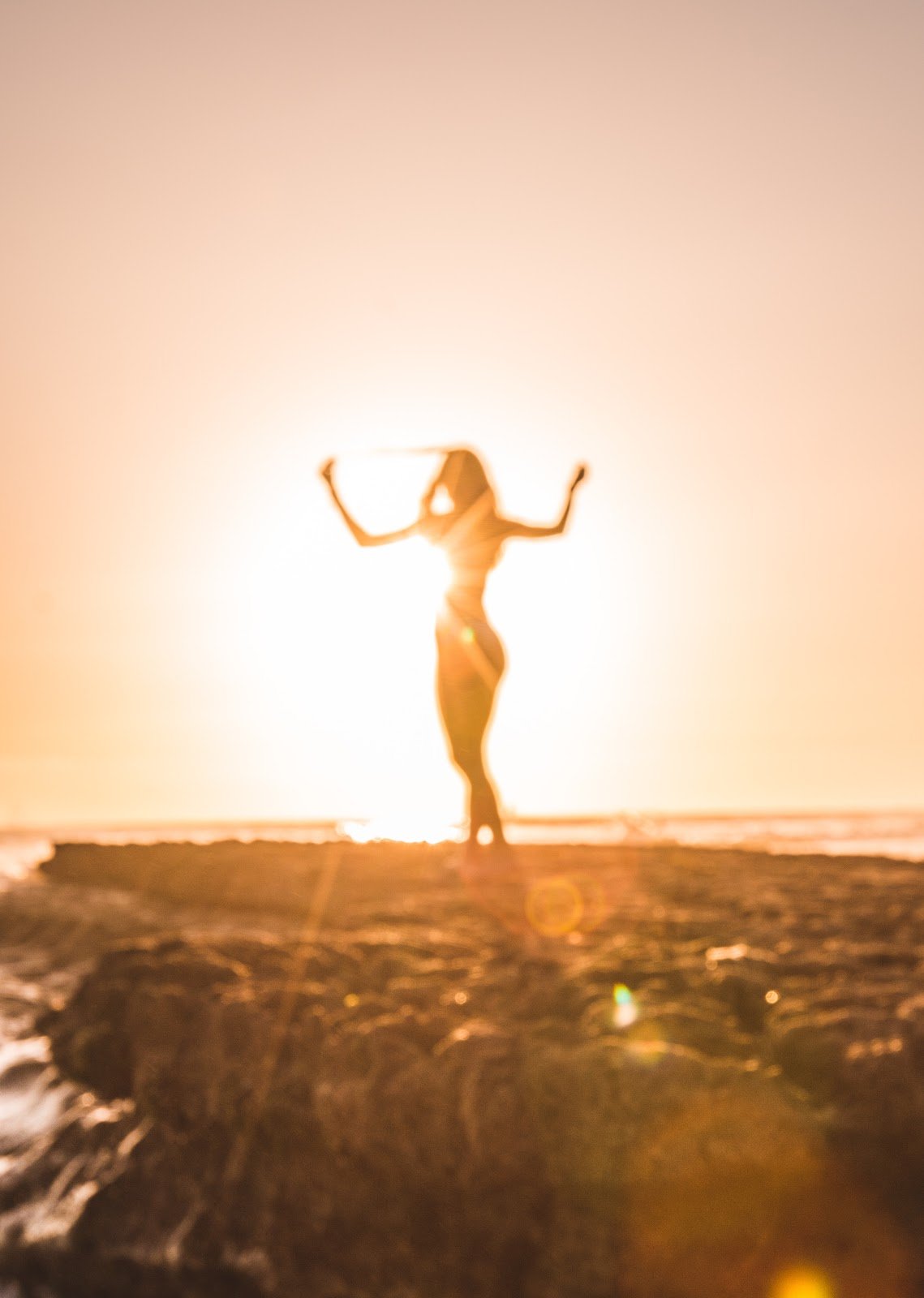 silhouette-of-woman-near-cliff-at-sunset