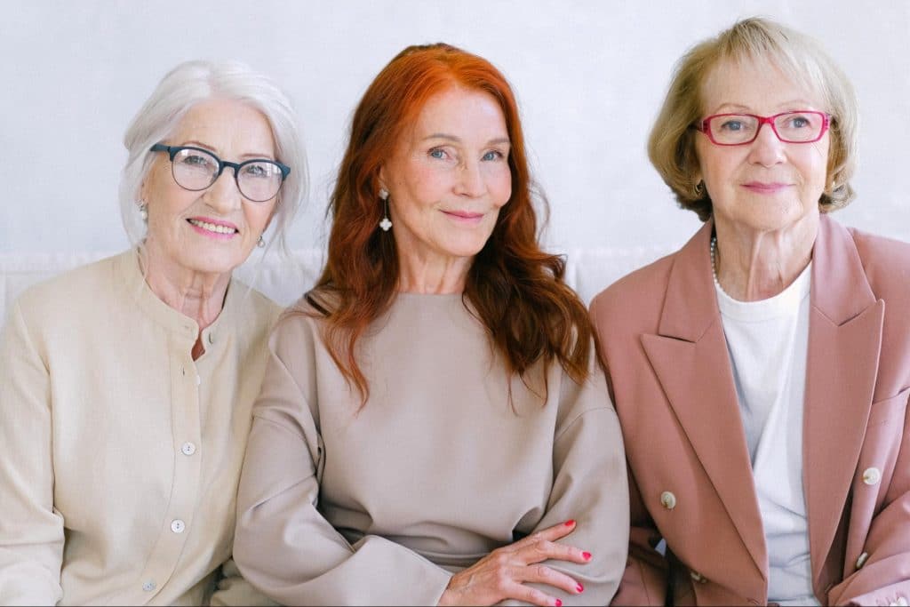 Three senior ladies smiling at the camera. Probiotics can help seniors stay regular and avoid constipation.