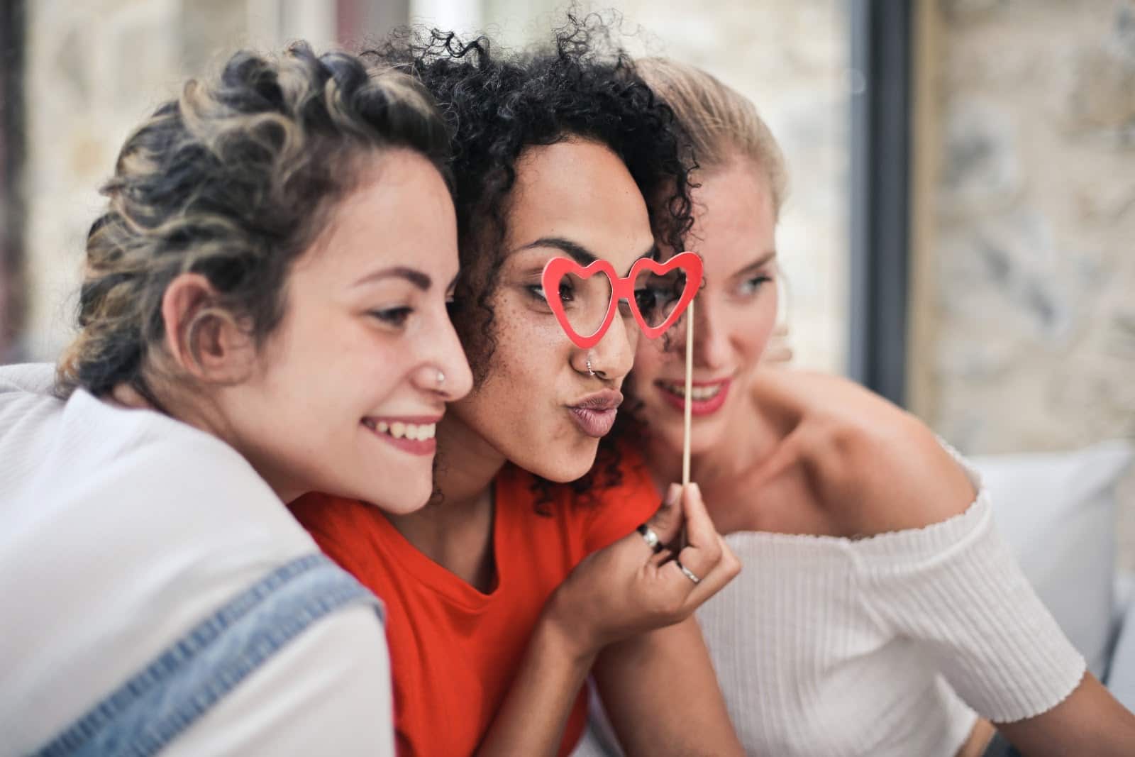 three-women-posing-for-photo-with-silly-mask