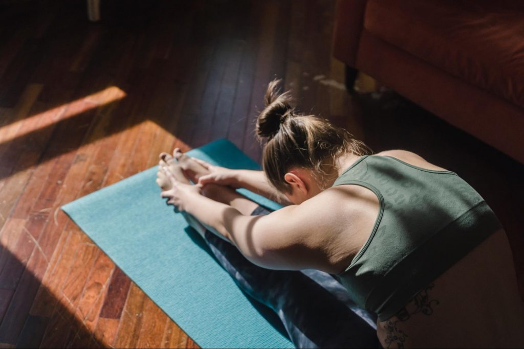 womain doing yoga stretch inhouse