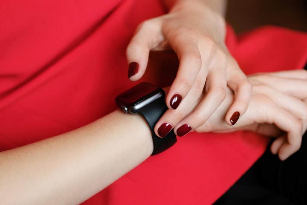 A woman checks the time on her smart watch. Maintaining a regular schedule for taking prebiotics is key to making sure they are as effective as possible. 