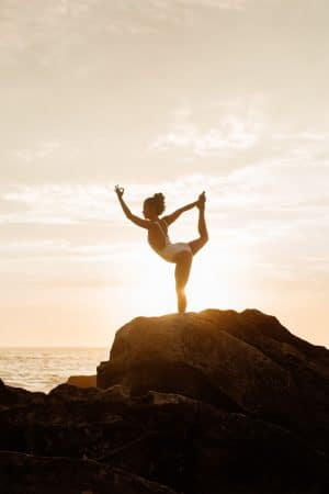 woman-in-white-one-piece-swimsuit-doing-yoga