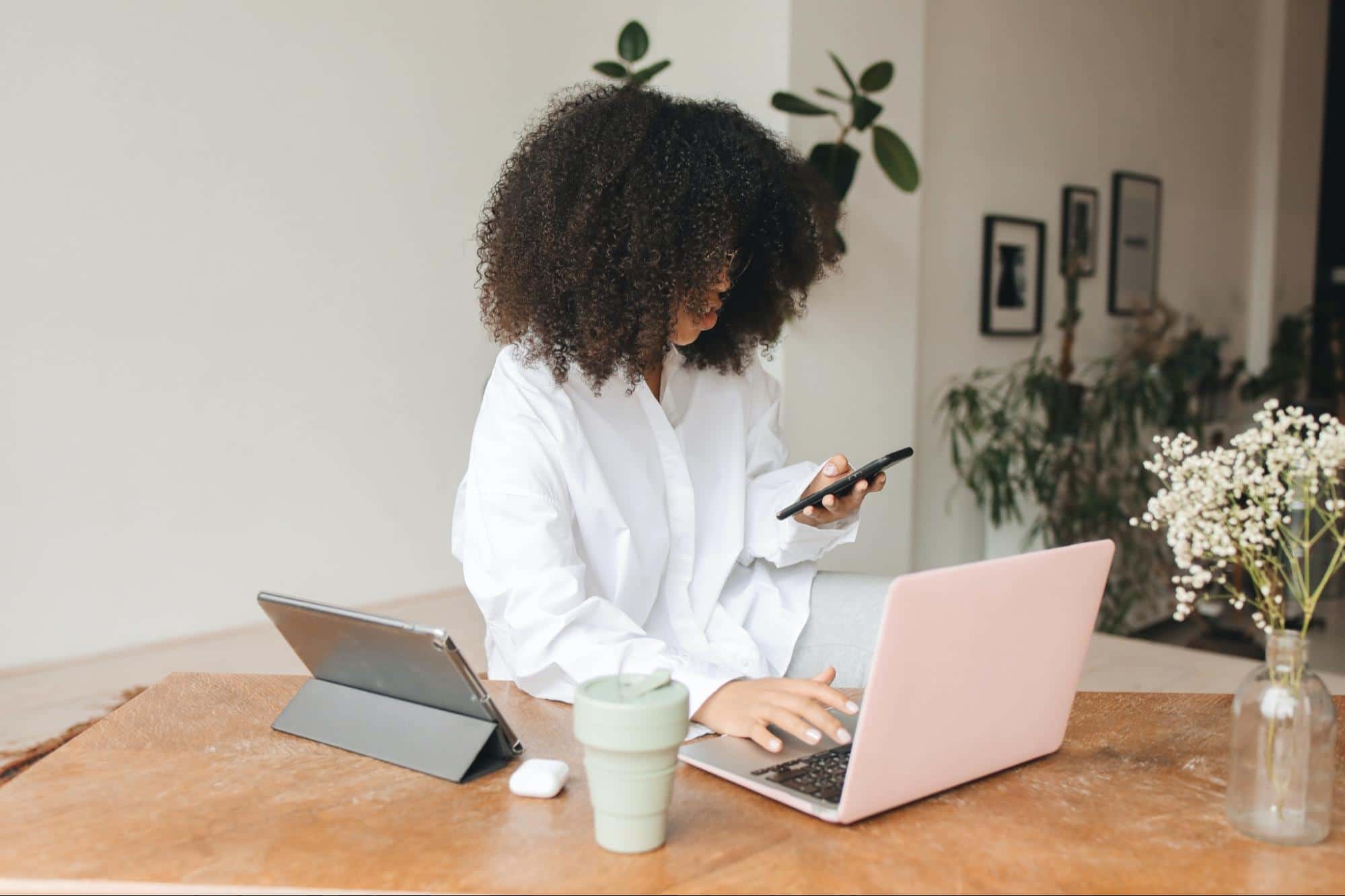 Young woman checks notifications on phone.